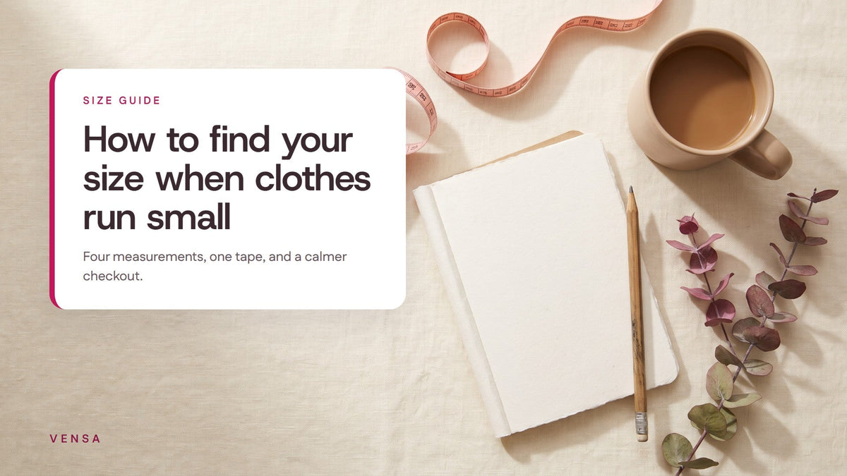 Pink tape measure, blank notebook, pencil and coffee on a cream linen table with the title How to find your size when clothes run small