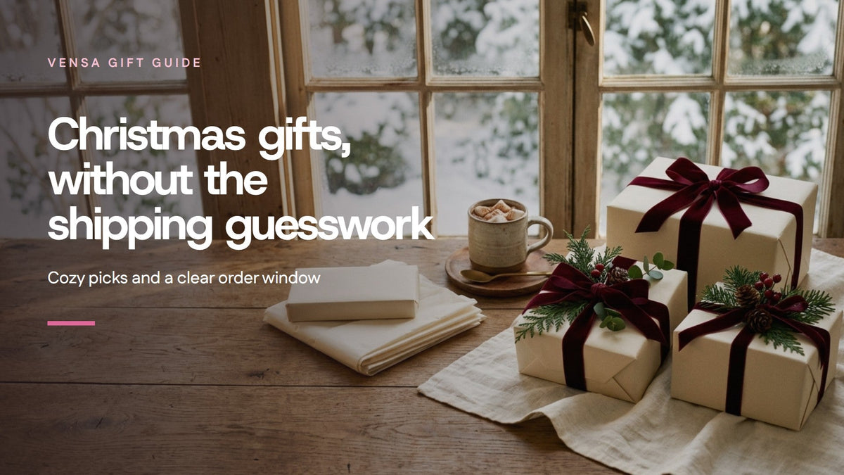 Wrapped Christmas gifts on a wood table beside a winter window