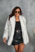 Woman wearing a frost white shaggy faux fur coat with a black leather skirt