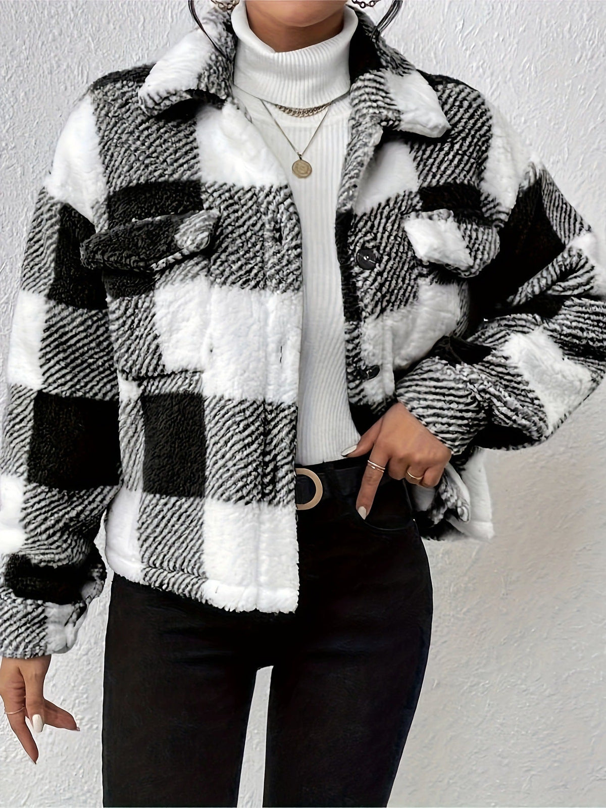 Woman in a black and white plaid sherpa shacket