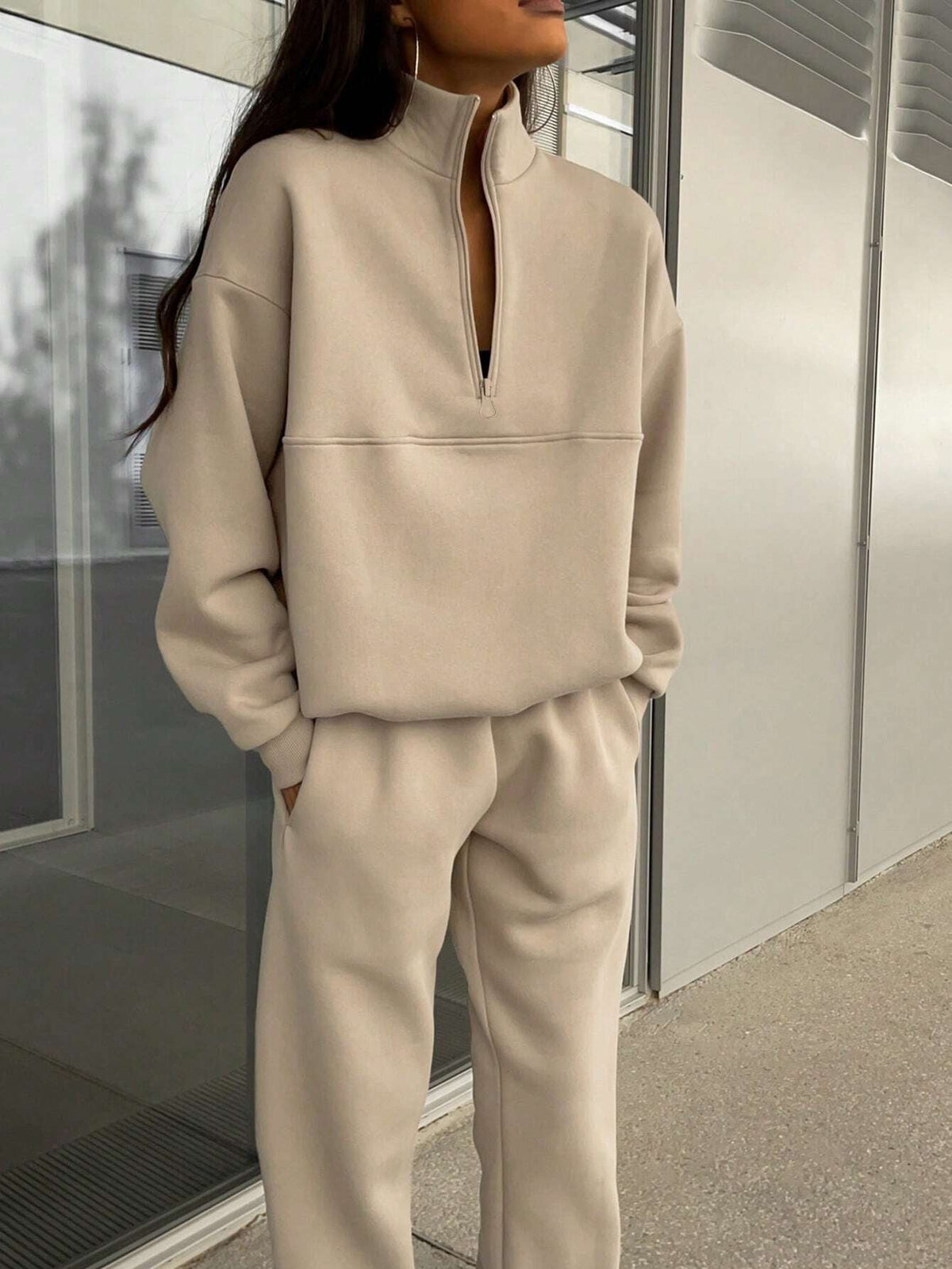 Woman in a beige half-zip sweatshirt and jogger set