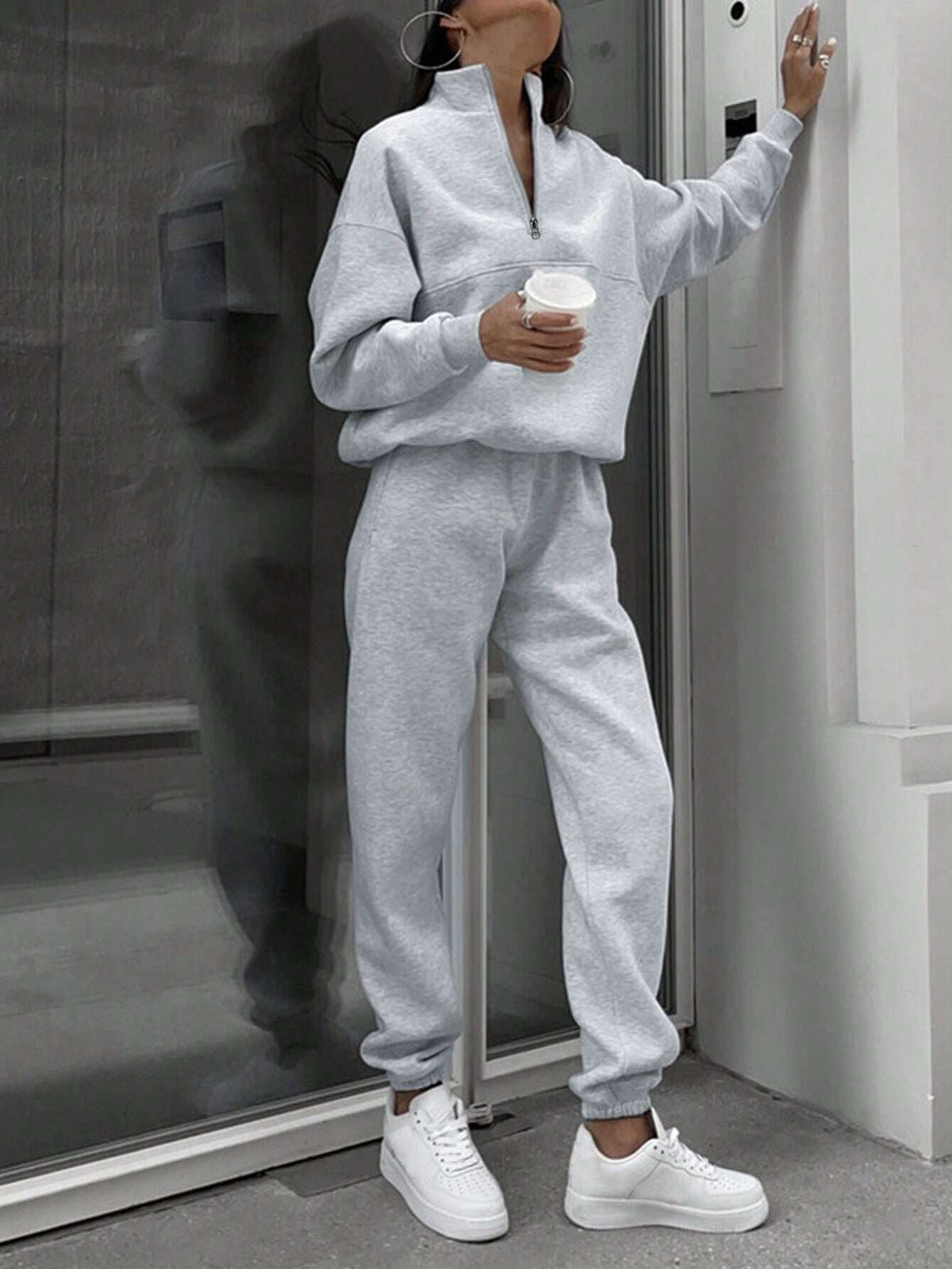 Woman in a gray half-zip sweatshirt and jogger set